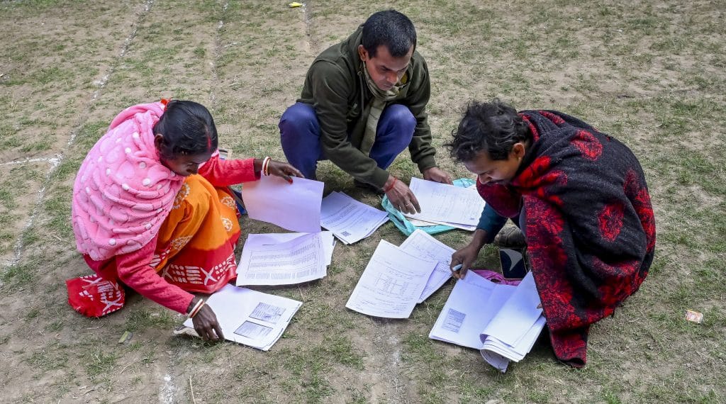 People arrange their documents during a hearing under the Special Intensive Revision (SIR) of electoral rolls, in Nadia, West Bengal. Photo: PTI.