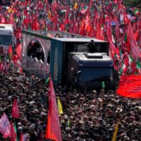 At Tehran’s Grand Mosalla, red flags reading “O avengers of Hussein” linked Washington’s assassination of Ayatollah Ali Khamenei to the martyrdom of Karbala and turned mourning into a call for resistance.