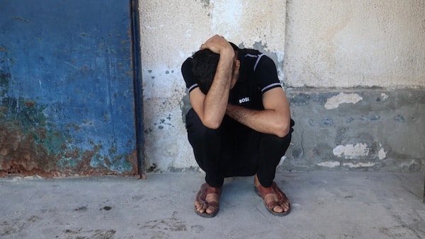 A Palestinian mourns the death of Al Jazeera journalist Ahmed Wishah, who was killed in an Israeli strike, at Al-Aqsa Martyrs Hospital in Deir el-Balah in the central Gaza Strip in 21 June 2026 (Eyad Baba/AFP)