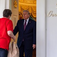 DoorDash worker Sharon Simmons is summoned to the White House to deliver McDonald's to President Donald Trump as part of a publicity stunt at the White House, April 13, 2026, in Washington. DoorDash is backing Republican efforts to strip D.C. of several financial powers that are key to Home Rule. | Alex Brandon / AP
