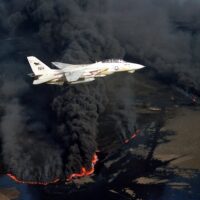 U.S. Navy Grumman F-14A Tomcat flying over a Kuwaiti oil well set ablaze by Iraqi troops during the 1991 Gulf War. (Photo: Lt. Steve Gozzo, U.S. Navy)