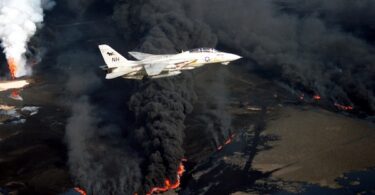 U.S. Navy Grumman F-14A Tomcat flying over a Kuwaiti oil well set ablaze by Iraqi troops during the 1991 Gulf War. (Photo: Lt. Steve Gozzo, U.S. Navy)