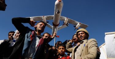 Supporters of Ansar Allah hold a mock drone drone during a rally against the U.S.-led strikes on Yemen and Israel’s war in Gaza Strip, in Sanaa, Yemen, Feb. 23, 2024. Photo: Osamah Abdulrahman/AP.