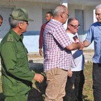 Cuban President Miguel Díaz-Canel, right, meets with water supply workers Aug. 27 in Havana. Cuba is taking steps to revive production crippled by U.S. rulers’ attacks, defend its revolution.