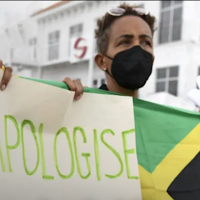 Jamaicans demanding slavery reparations from UK protest outside the entrance of the British High Commission during the visit of the Duke and Duchess of Cambridge in Kingston, Jamaica, March 22, 2022. Photo: AFP.