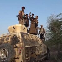 Yemeni soldiers stand on top of a damaged, abandoned vehicle belonging to Saudi-backed forces. September 2026. (Photo credit: Yemen Military Media)