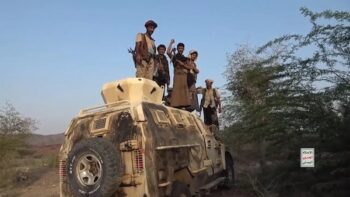 Yemeni soldiers stand on top of a damaged, abandoned vehicle belonging to Saudi-backed forces. September 2026. (Photo credit: Yemen Military Media)