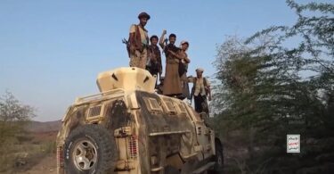 Yemeni soldiers stand on top of a damaged, abandoned vehicle belonging to Saudi-backed forces. September 2026. (Photo credit: Yemen Military Media)