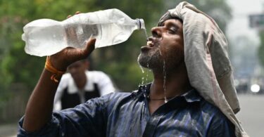 A worker cools off with water during extreme heat in Amritsar, India. El Niño raises the temperature, but who survives the heat is decided by wages, housing, electricity, health care and the conditions capitalism imposes on working people.