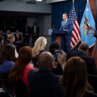 Secretary of War Pete Hegseth and Joint Chiefs Chair Gen. Dan Caine brief reporters at the Pentagon on the U.S. war on Iran, March 10, 2026. Artificial intelligence does not choose the war. The Pentagon does that. Department of War photo by Petty Officer 1st Class Eric Brann.