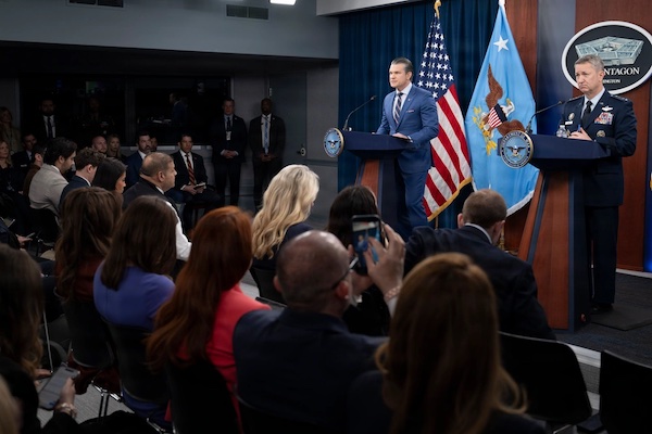 Secretary of War Pete Hegseth and Joint Chiefs Chair Gen. Dan Caine brief reporters at the Pentagon on the U.S. war on Iran, March 10, 2026. Artificial intelligence does not choose the war. The Pentagon does that. Department of War photo by Petty Officer 1st Class Eric Brann.