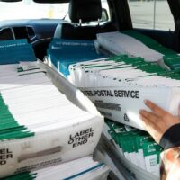 A Utah County election worker picks up mailed ballots from the United States Postal Service office on Oct. 26, 2020 in Provo, Utah. (Photo by George Frey/Getty Images)