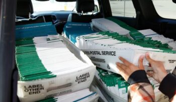 A Utah County election worker picks up mailed ballots from the United States Postal Service office on Oct. 26, 2020 in Provo, Utah. (Photo by George Frey/Getty Images)