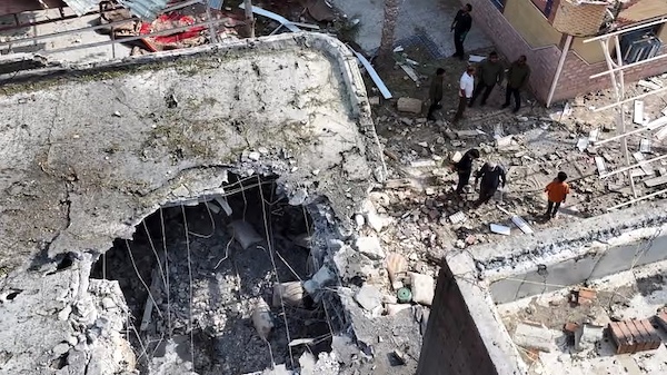 People inspect the wreckage of a house in Kuhestak, Iran, hit by a U.S. missile during a family wedding on Sept. 1.