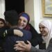 Israa Jaabis, center, a Palestinian prisoner released by Israel, is hugged by relatives as she arrived home in East Jerusalem, Nov. 26, 2023.