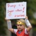 A young demonstrator holds a banner objecting to the visit of U.S. President Donald Trump to the United Kingdom, in Belfast