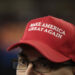 A man wearing a Make America Great Again hat. Only the upper half of his face is visible.