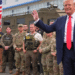 President Donald Trump waves while meeting with members of law enforcement, including National Guard soldiers, in Washington on Thursday, Aug. 21, 2025. | Jacquelyn Martin / AP